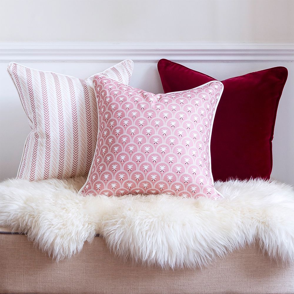 A rich and luxurious cranberry red velvet cushion 