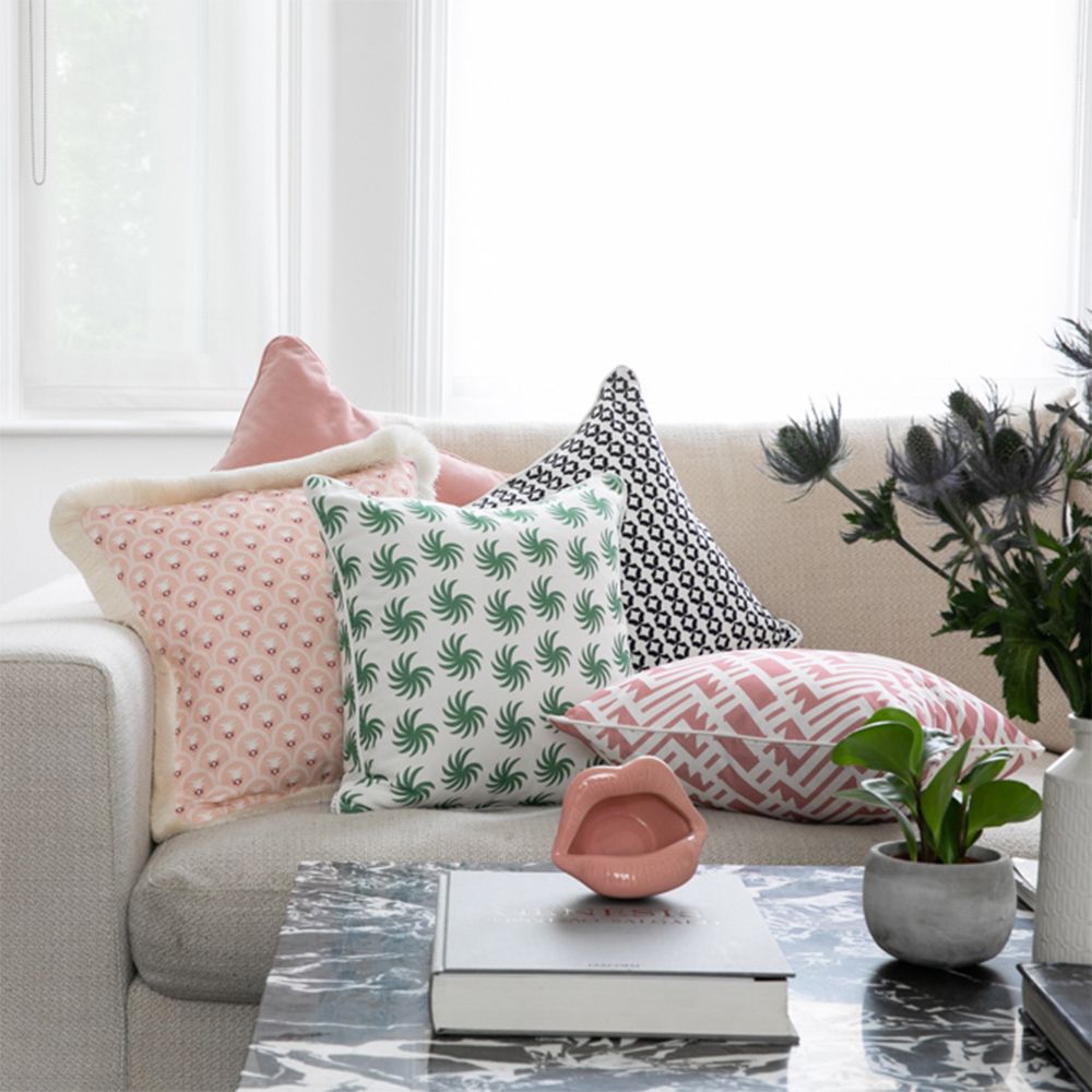 A lovely light pink velvet square shaped cushion 
