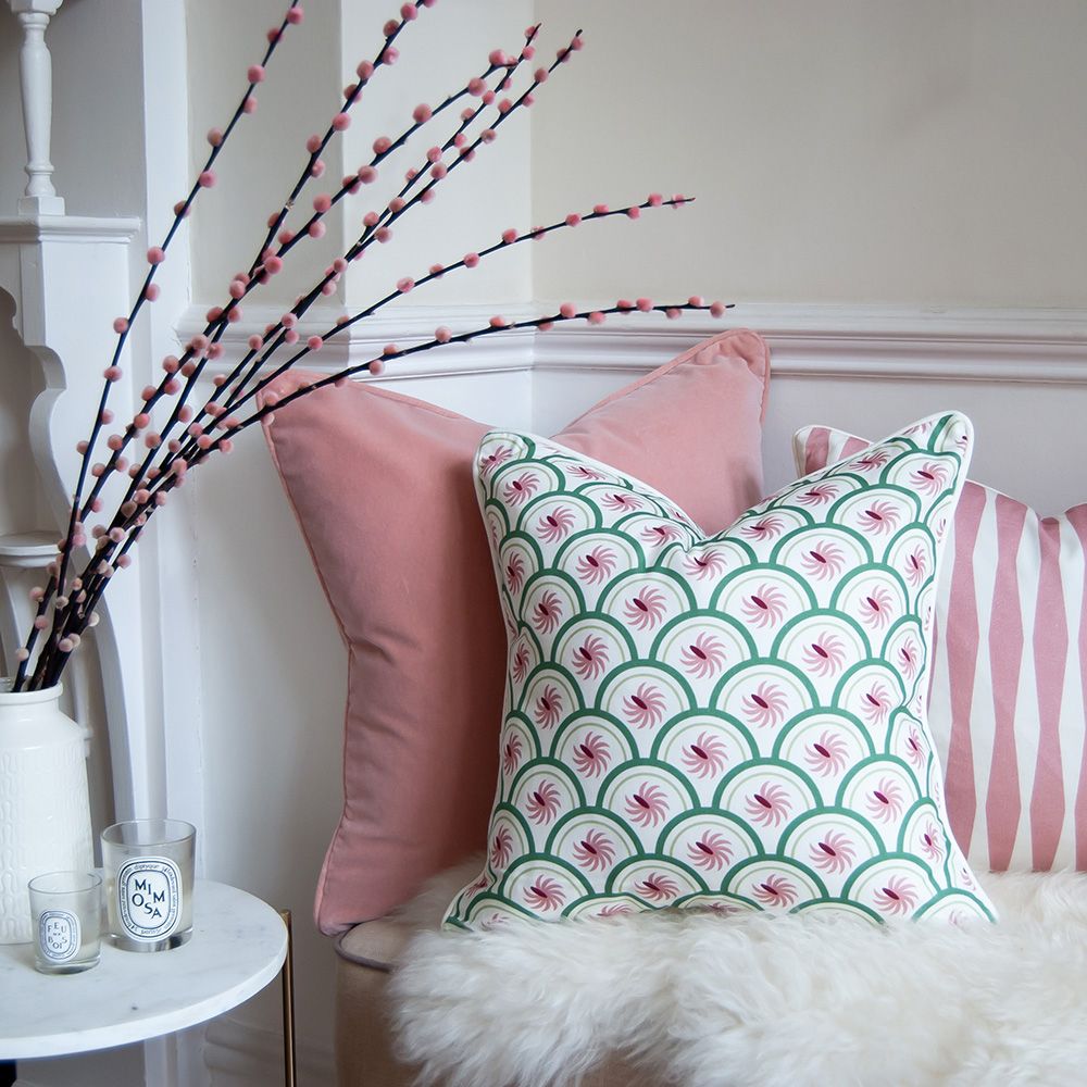 A lovely light pink velvet square shaped cushion 