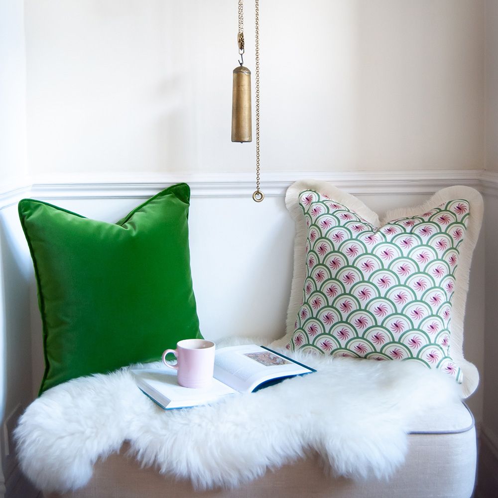 A rich dark green velvet cushion 