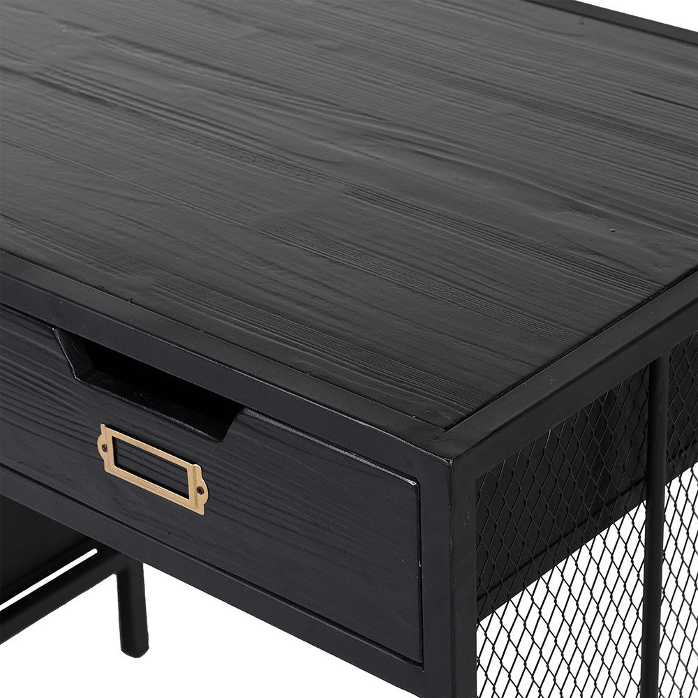 A black, industrial style desk with six drawers and brass detailing