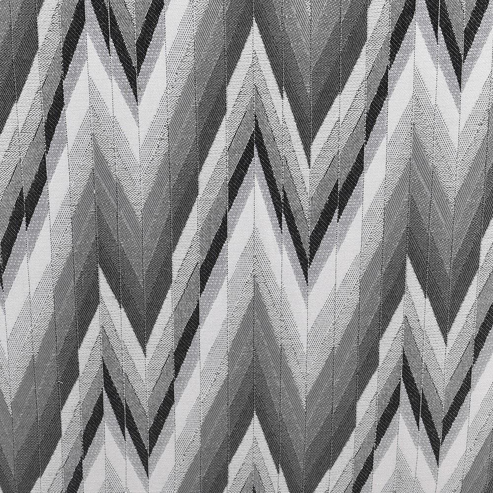 A quirky patterned armchair with a gorgeous grey upholstery 