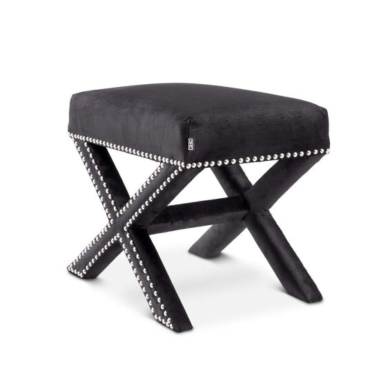 A gorgeous velvet upholstered cross legged stool with nickel studs.