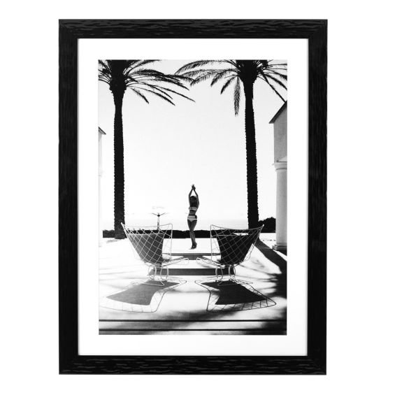 A tropical print by Eichholtz with a black frame 