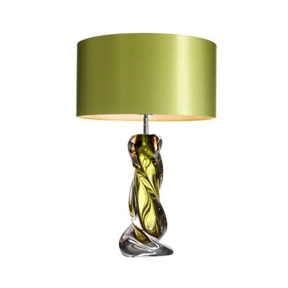 A luxurious hand blown glass lamp with a green tint and matching shade