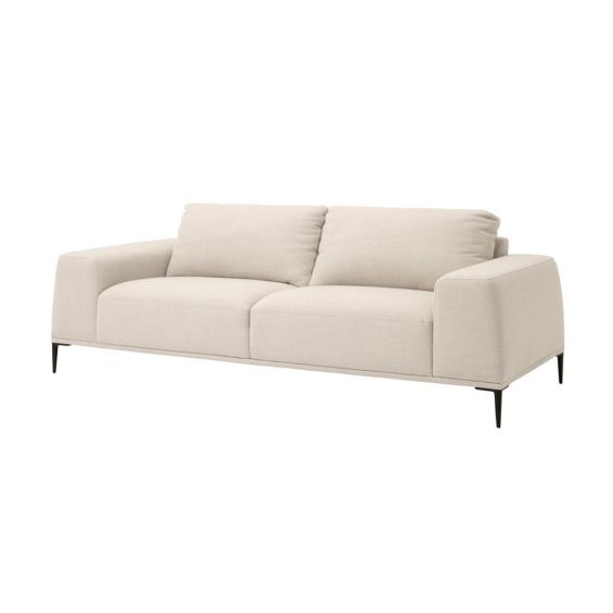 Designer contemporary shaped sofa with oversized arms and overfilled cushions on sharp legs upholstered in a natural fabric