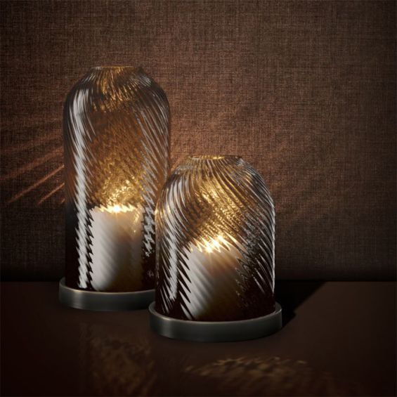 A luxury hurricane candle holder by Eichholtz with a bronze finish