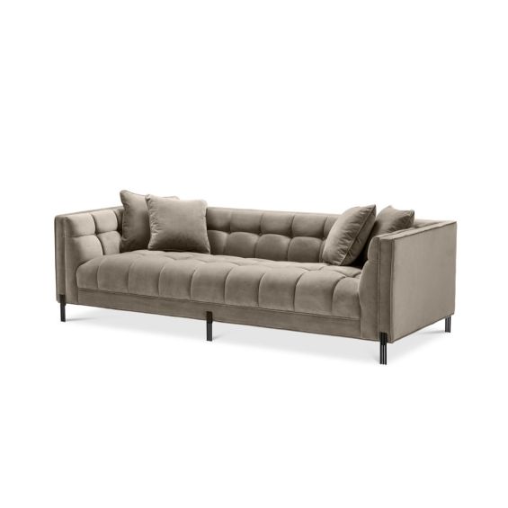 A luxurious sumptuous deep-buttoned sofa with grey velvet upholstery and black legs 