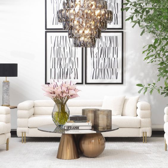 A luxurious sofa by Eichholtz with Art Deco undertones and glamorous golden feet