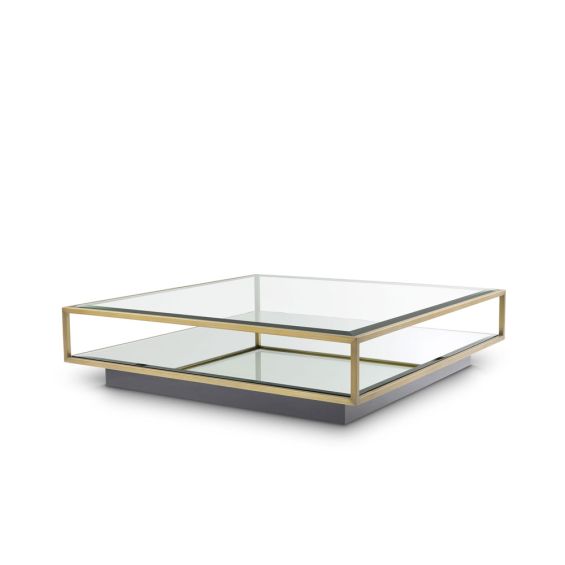 A contemporary glass coffee table with a brushed brass finish