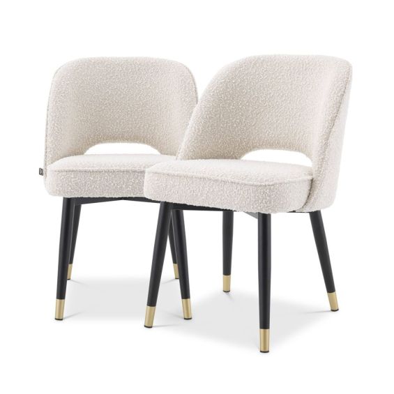 Stunning upholstered chair with black tapered legs and brass caps. 