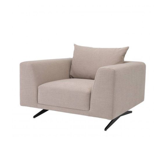 A luxurious contemporary armchair with sand-coloured upholstery and contrasting black legs 