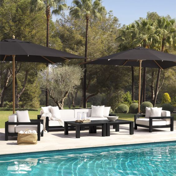 A luxurious outdoor sofa with a black-toned frame and natural-coloured upholstery 