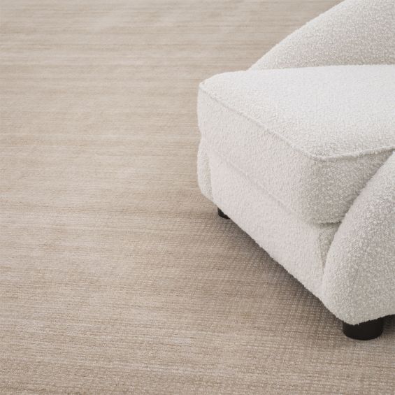 Beige toned low pile rug with a smooth velvet finish by Eichholtz