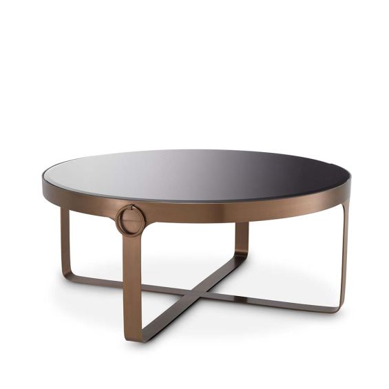 An industrial décor inspired coffee table in a copper finish and a black glass top.