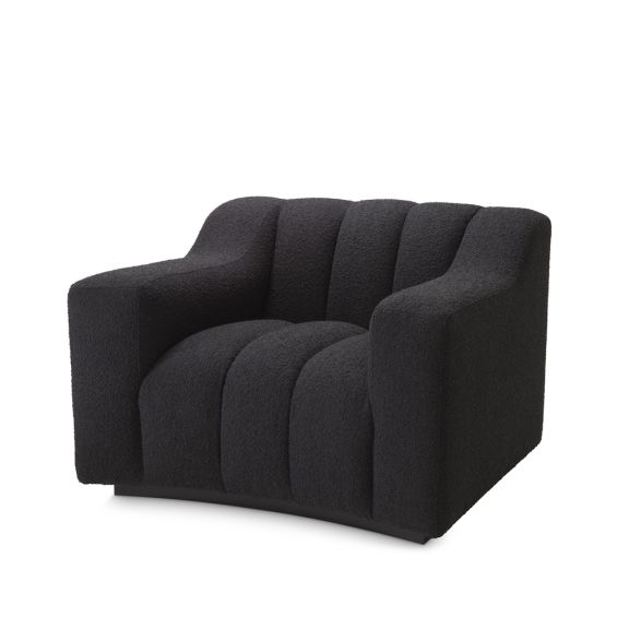 A sumptuous and sophisticated black boucle armchair