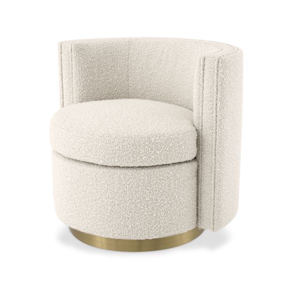 A glamorous boucle cream armchair with a brass swivel base
