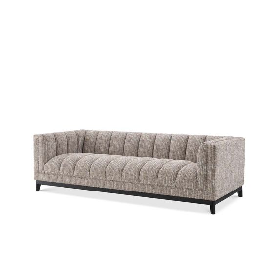 A gorgeous rustic inspired sofa upholstered in a beige fabric with black features.