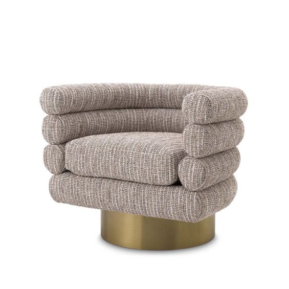 A beige upholstered swivel chair on a brushed brass base.