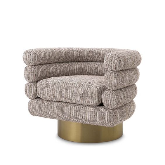 A beige upholstered swivel chair on a brushed brass base.