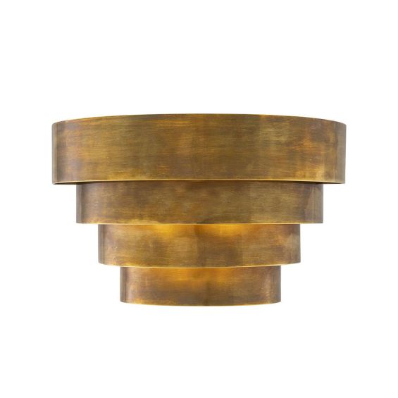 A statement wall lamp by Eichholtz with a vintage brass finish