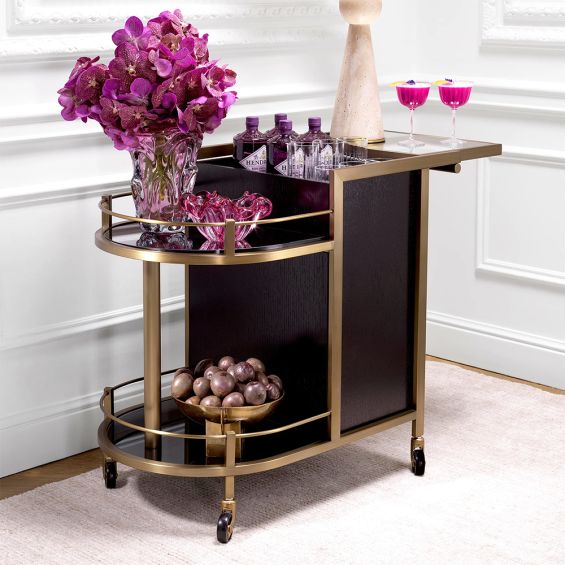 A contemporary drinks trolley by Eichholtz with a glamourous brushed brass finish 