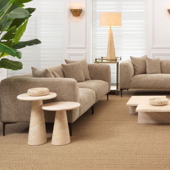 Sculpturally appealing side table in refreshing natural travertine finish