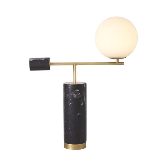 A striking, sculptural side lamp by Eichholtz crafted from black marble and finished with a spherical white glass shade and antique brass details