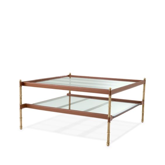 A sophisticated coffee table with vintage brass legs and lined with tanned leather