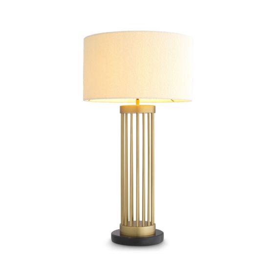 A luxury side lamp by Eichholtz with a black marble base, cylindrical antique brass frame and boucle lampshade