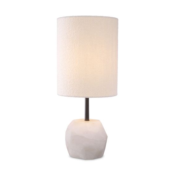 A luxury table lamp by Eichholtz carved from alabaster with an elongated boucle cylindrical shade