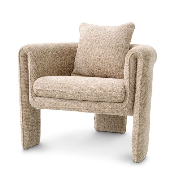 A curvaceous armchair with a contemporary chic upholstery and complementary scatter cushion