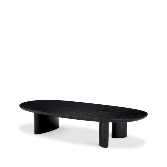 A sophisticated coffee table by Eichholtz with playfully asymmetrical legs and a beautiful black finish