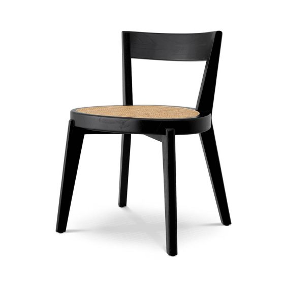 A rattan base dining chair with tapered legs and black frame