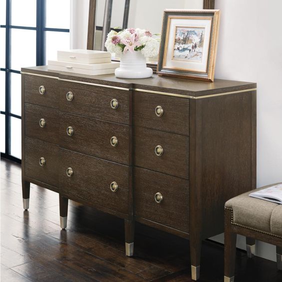 A sophisticated dresser from Bernhardt with a burnished brass and white oak veneer finish, six legs and nine drawers