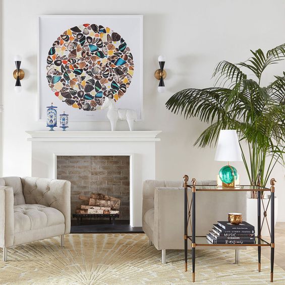 A regal brass and black French Empire-inspired side table with glass shelves