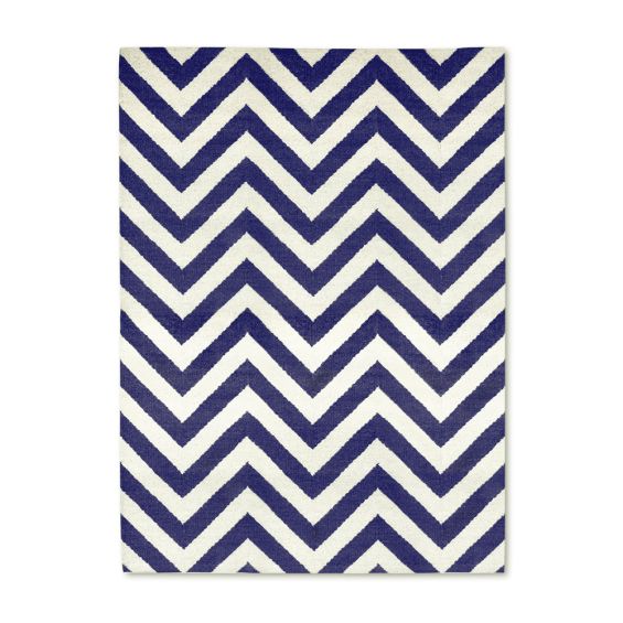 A bold blue and white reversible rug by Jonathan Adler with a zigzag pattern 