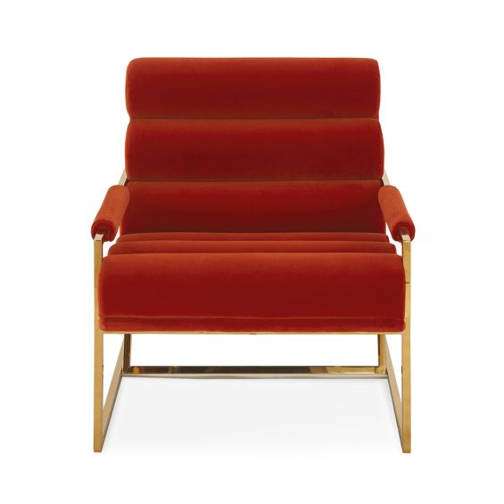 A mid-century modern inspired armchair with burnt orange velvet and a polished brass frame