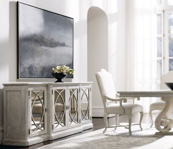Elegant, distressed sideboard with decorated panel doors.