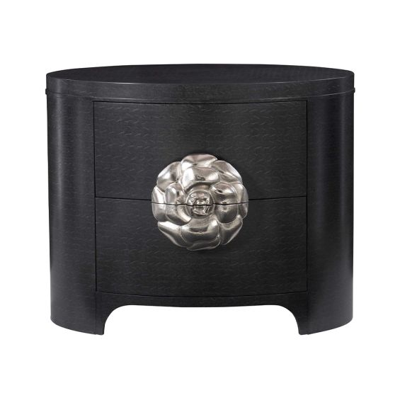A sophisticated oval shaped two drawer bedside table with a silver aluminium flower hardware pull