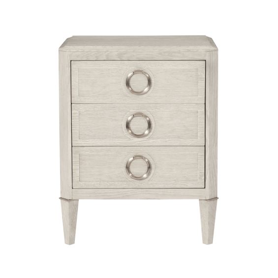 A luxurious natural oak wood three drawer bedside table with tarnished nickel details