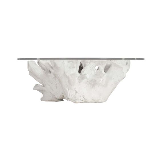 A white cast tree stump based coffee table with a glass top.