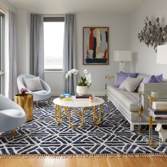 contemporary marble table with a single sinuous brass tube base 