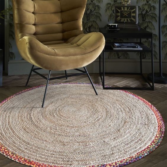 A luxurious, round handwoven hemp rug with a multicoloured rim