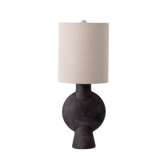 A bold, brutalist inspired table lamp made from terracotta with a linen shade