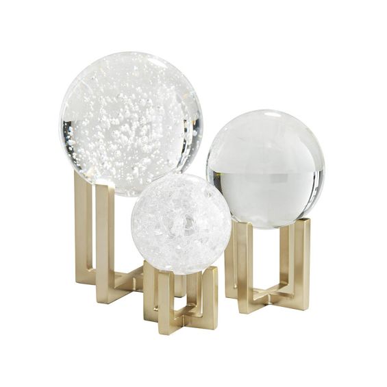 Set of three crystal balls sat atop a sculptural brass base each