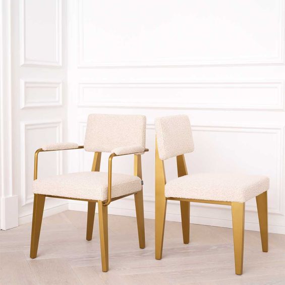 A luxurious brushed brass and boucle dining chair with arms 