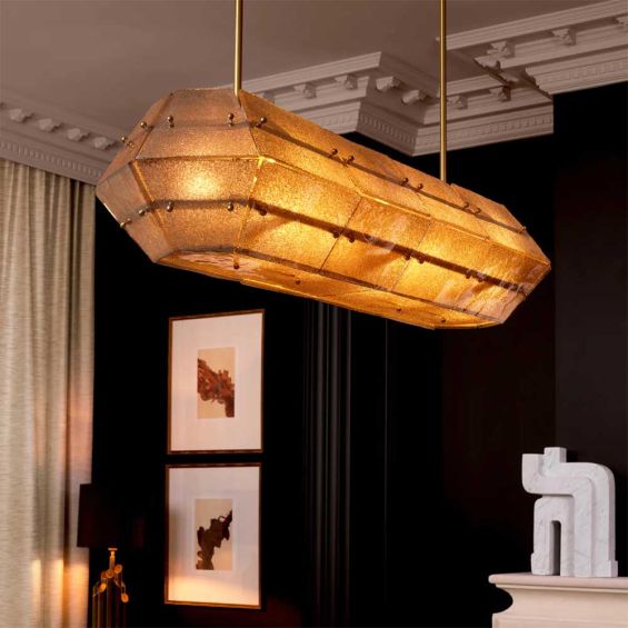 Handmade glass panels with an antique brass finish cast a warm, ambient glow.