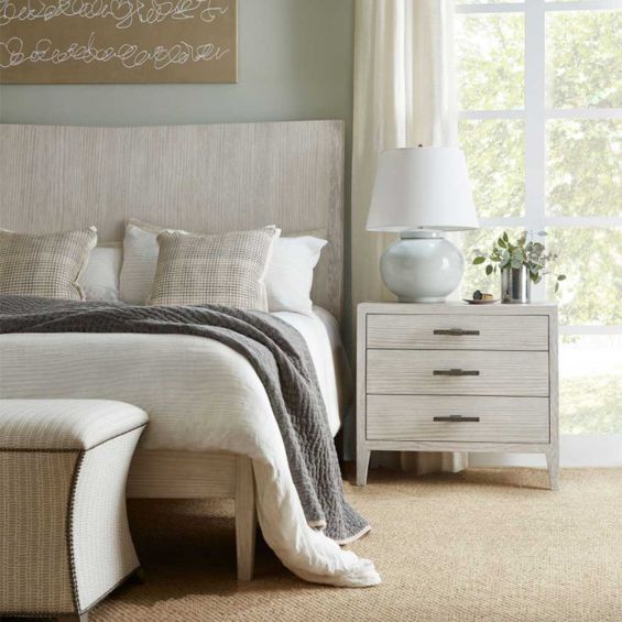 Three drawer whitewood bedside table with brown metal handles