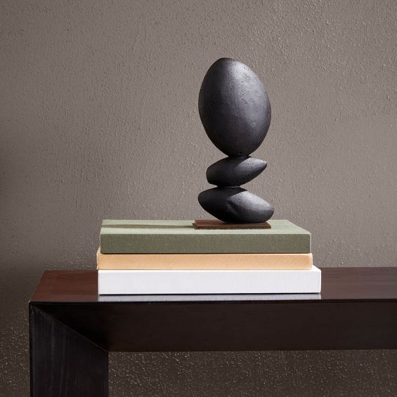 Black tiered stone-like sculpture on on gold base